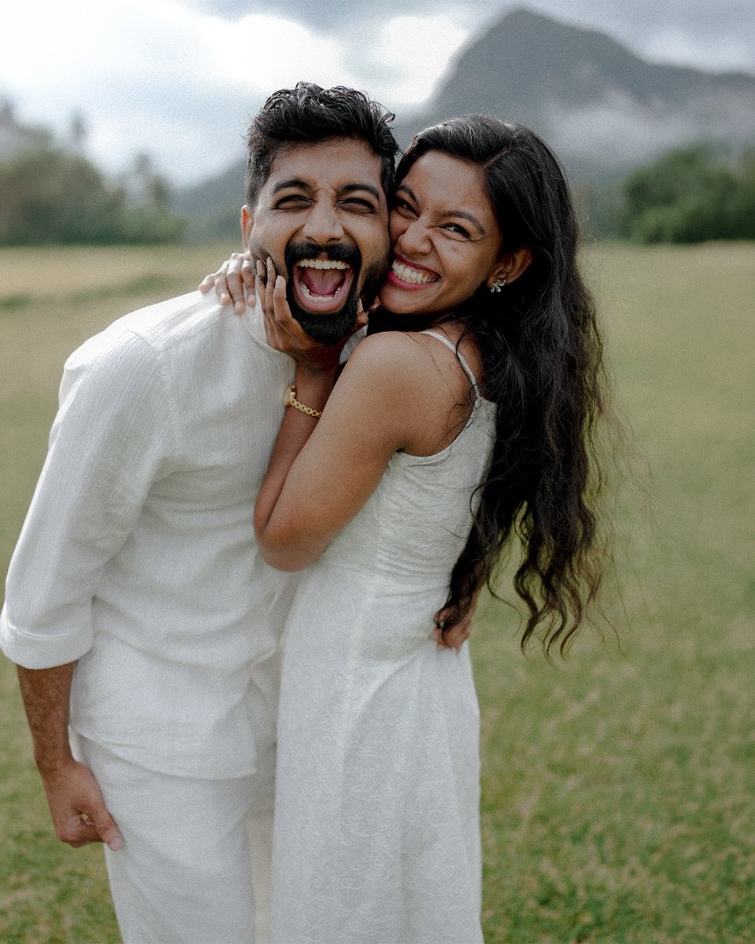 A joyful couple embracing in an open field
